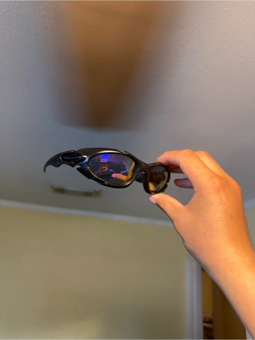 Sleek Black Curved Sunglasses with Mirrored Lenses Oakley Oakleys